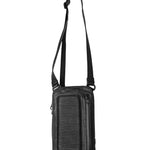 Close-up of the top of a black leather shoulder bag, with a focus on the adjustable strap and metal buckle details.