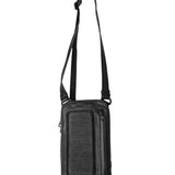 Close-up of the top of a black leather shoulder bag, with a focus on the adjustable strap and metal buckle details.