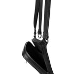 Close-up of the open main compartment of a black leather shoulder bag, illustrating the satin lining and internal pocket configuration.