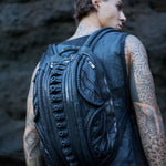 avant-garde leather backpack with biomorphic alien design aesthetic in post-apocalyptic dark fashion