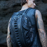 avant-garde leather backpack with biomorphic alien design aesthetic in post-apocalyptic dark fashion
