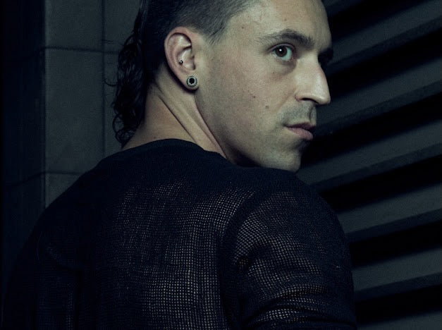 Rear three-quarter view of the black SYZMIC MESH T-SHIRT 213 showing its semi-sheer mesh texture.