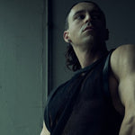 Low-angle front view of the black SYZMIC MESH TANK TOP 211 in textured organic cotton mesh.