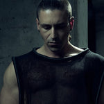 Front view of the black SYZMIC MESH TANK TOP 212 with semi-sheer mesh and tubular piping.