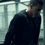 SYZMIC black panelled long-sleeve top worn by a model, showing curved chest panels.