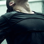 Close-up of the curved chest and shoulder panels on the SYZMIC black long-sleeve top.