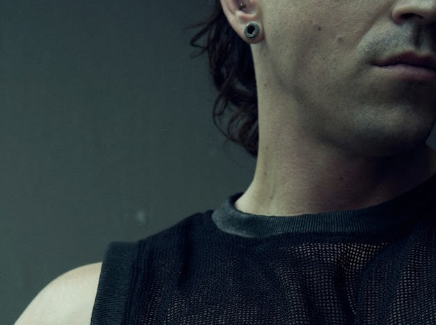 Close-up of the round neckline and black wax-coated rib trim on the SYZMIC MESH TANK TOP 211.