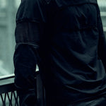 Detail of the layered sleeve panels and contrasting mesh on the SYZMIC black long-sleeve top.