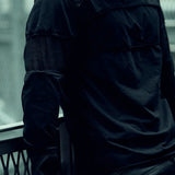 Detail of the layered sleeve panels and contrasting mesh on the SYZMIC black long-sleeve top.