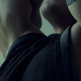 Close-up of the black SYZMIC MESH TANK TOP 211 armhole and textured mesh with the model's arm raised.