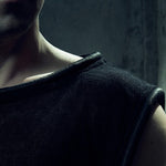 Close-up of the black MESH TANK TOP 212 showing textured cotton mesh and tubular neck trim.