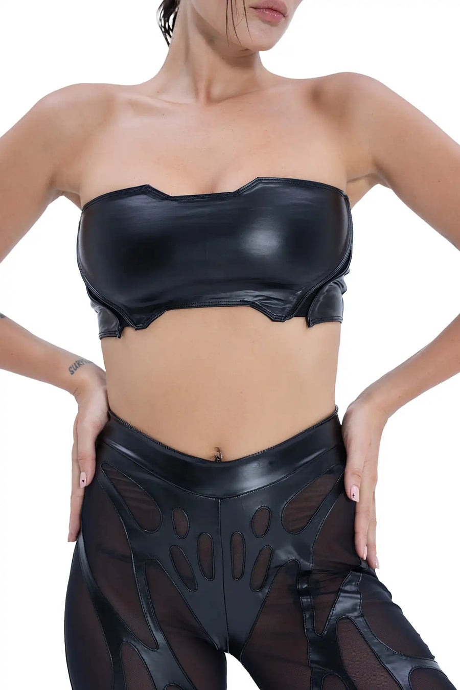 Front view of Syzmic Studio EIDOS-203 crop top in black vegan leather with biomorphic cutouts, avant-garde futuristic fashion.