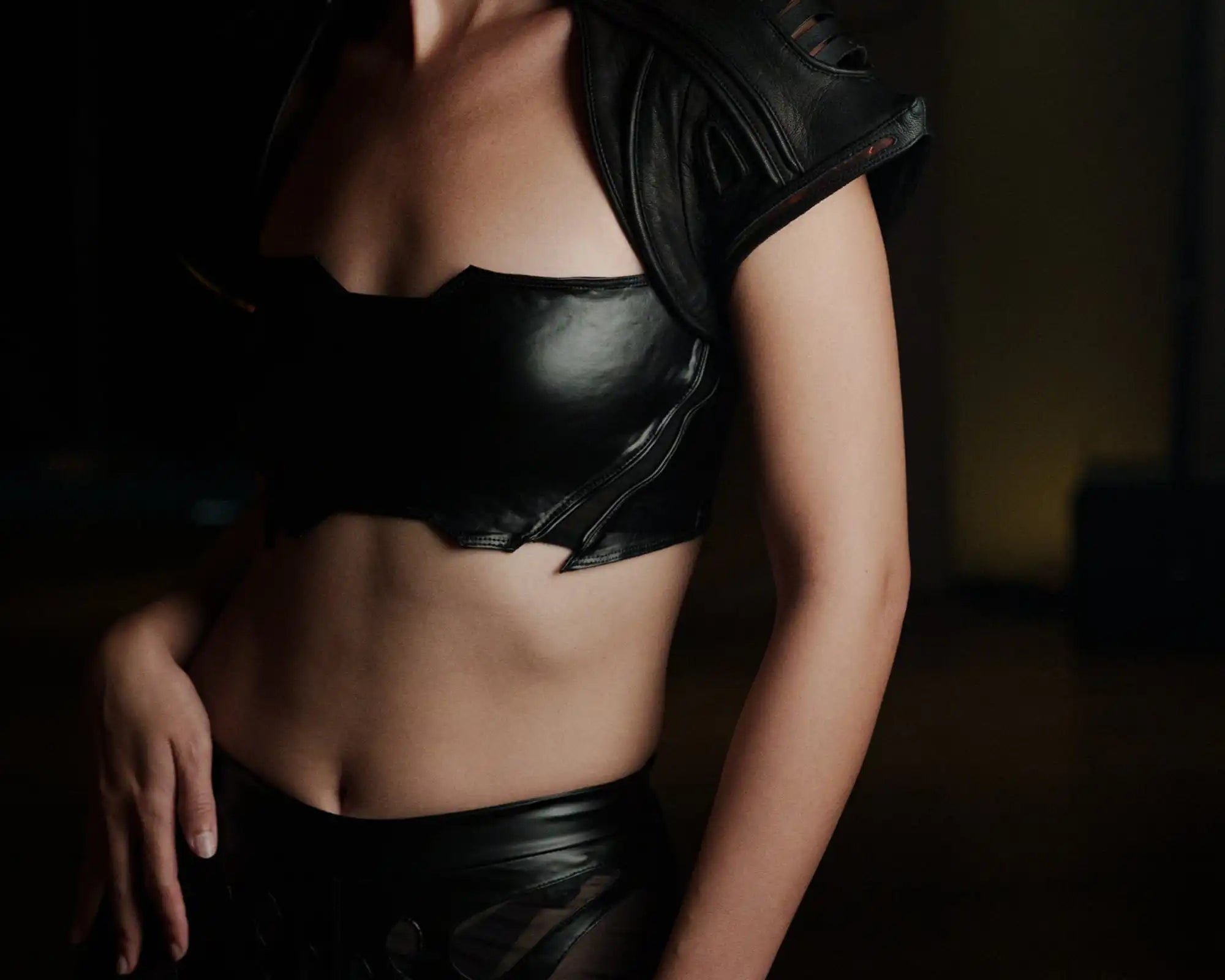 Close-up of Syzmic Studio EIDOS-203 crop top in black vegan leather, futuristic avant-garde fashion design.