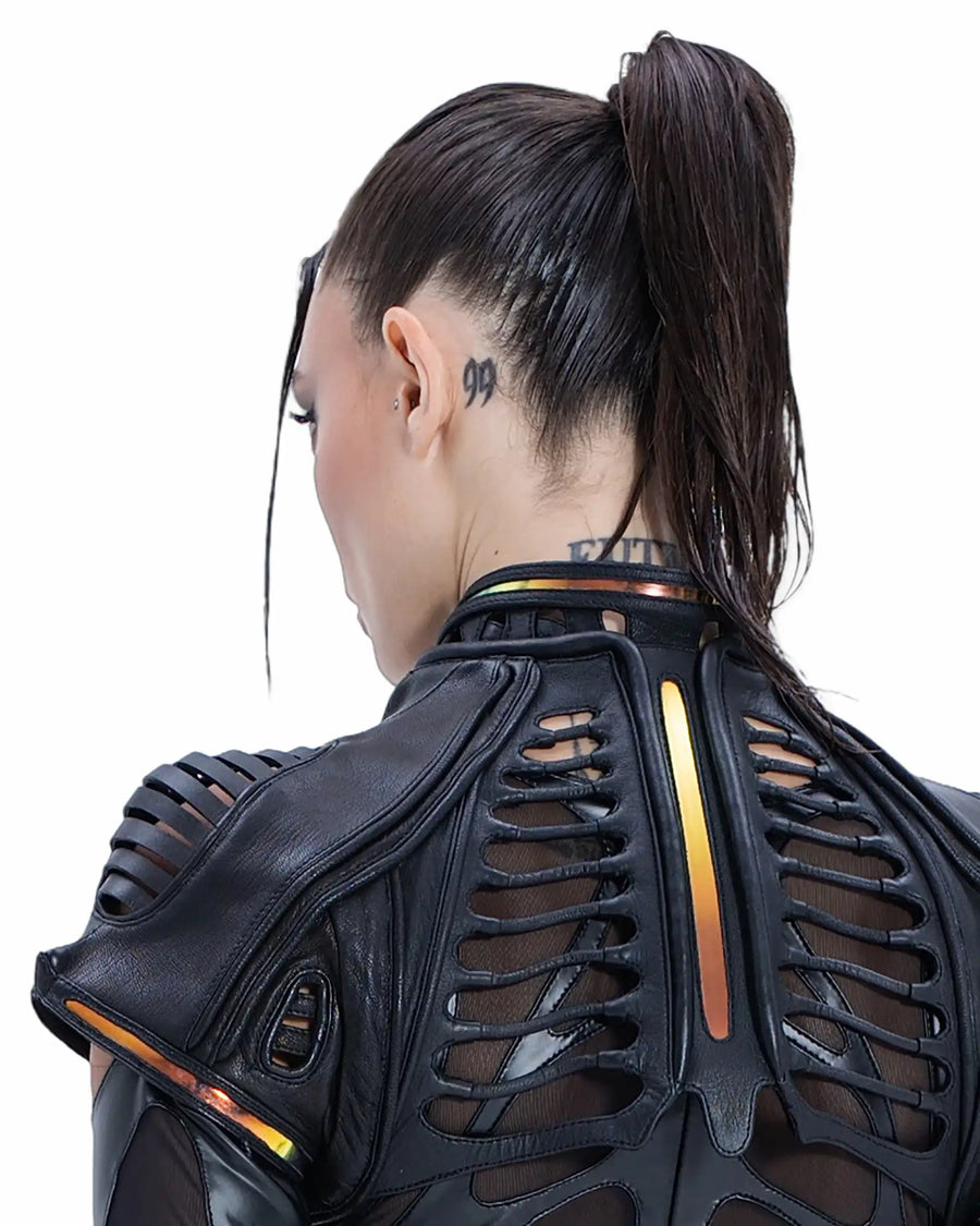 Back view of Syzmic Studio EIDOS-404 Exo-Jacket in black leather, featuring biomorphic cutouts and futuristic avant-garde design.