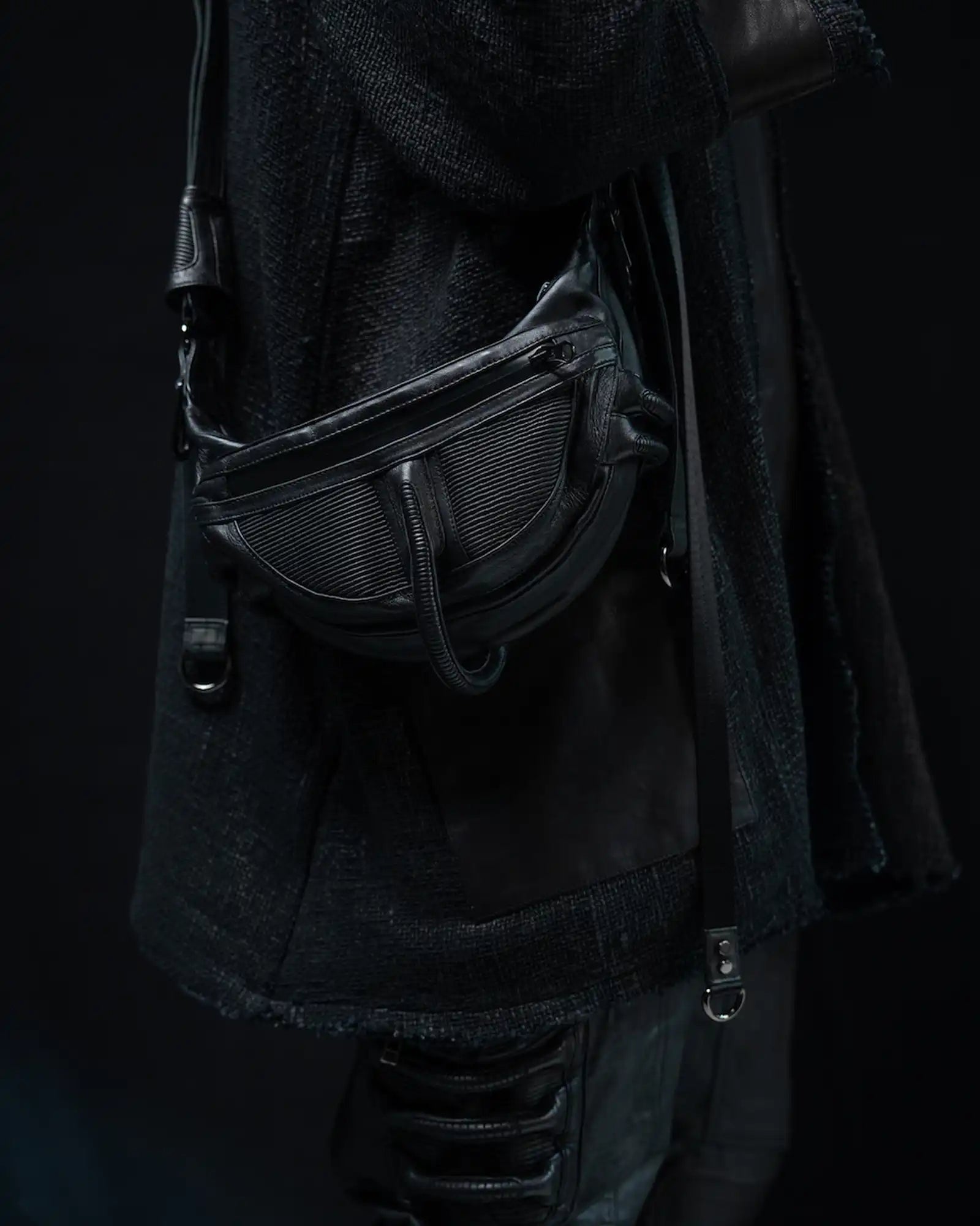 Close-up of Syzmic Studio KLEOS-511 leather holster bag in black, avant-garde design with futuristic detailing.