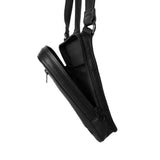 Close-up of the open main compartment of a black leather shoulder bag, illustrating the satin lining and internal pocket configuration.