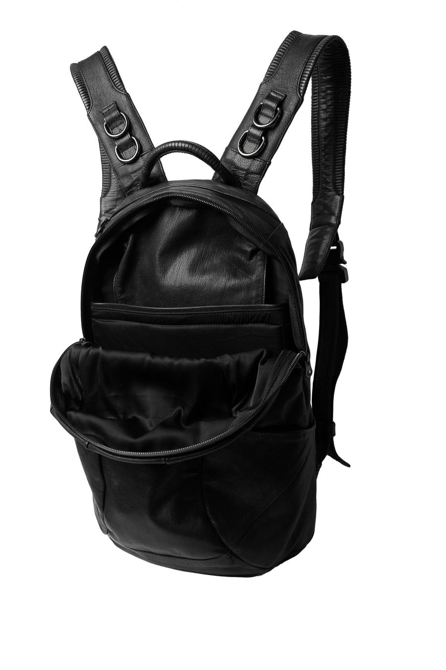 The black leather laptop backpack from Syzmic Studio with its main compartment unzipped, revealing a spacious interior with multiple pockets and a padded laptop sleeve, designed for both organization and style.