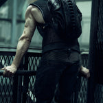 Rear view of a black sculptural SYZMIC backpack worn with a sleeveless top.