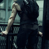 Rear view of a black sculptural SYZMIC backpack worn with a sleeveless top.