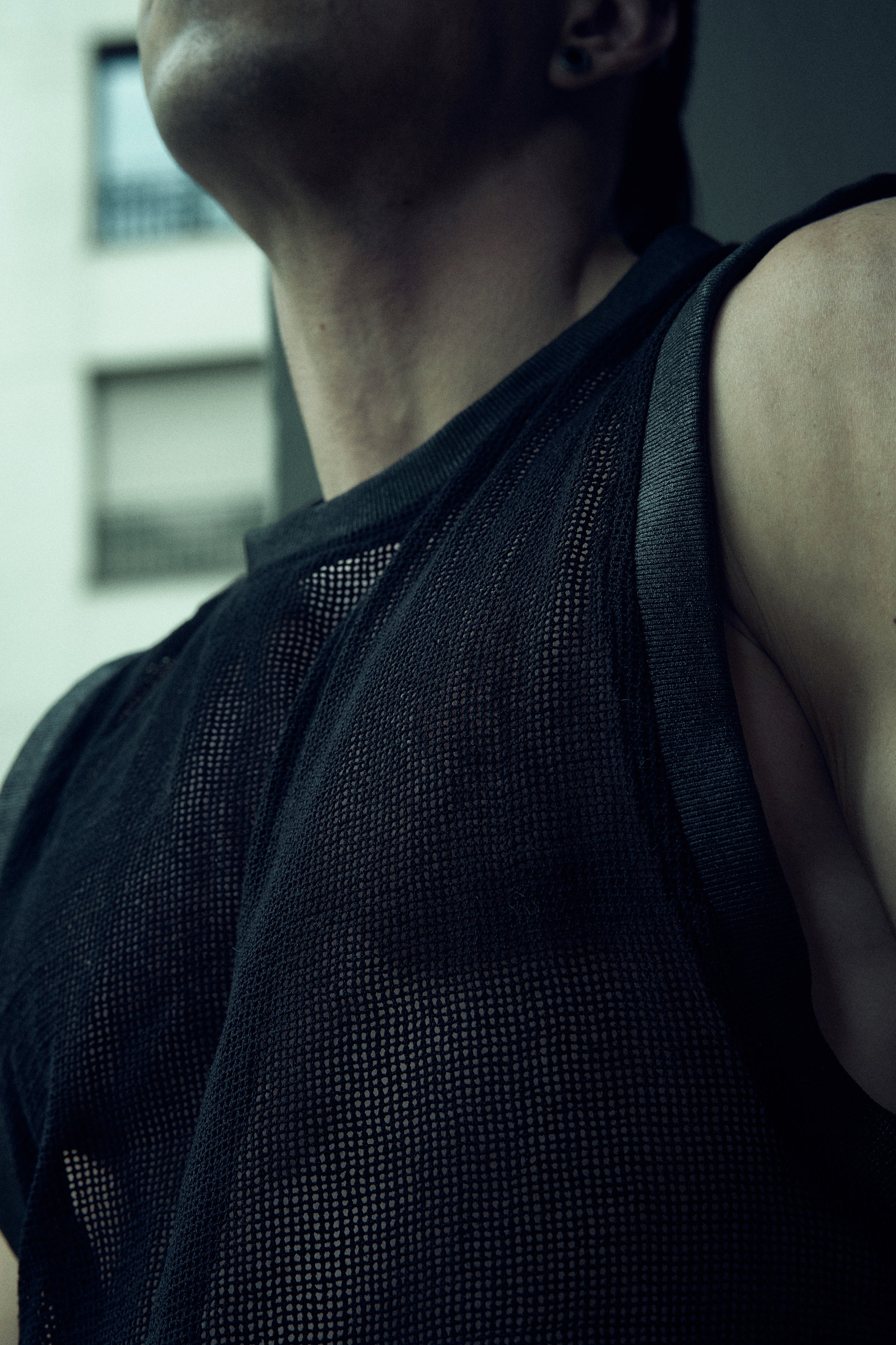 Black SYZMIC EIDOS-214 organic cotton mesh tank top photographed from below.