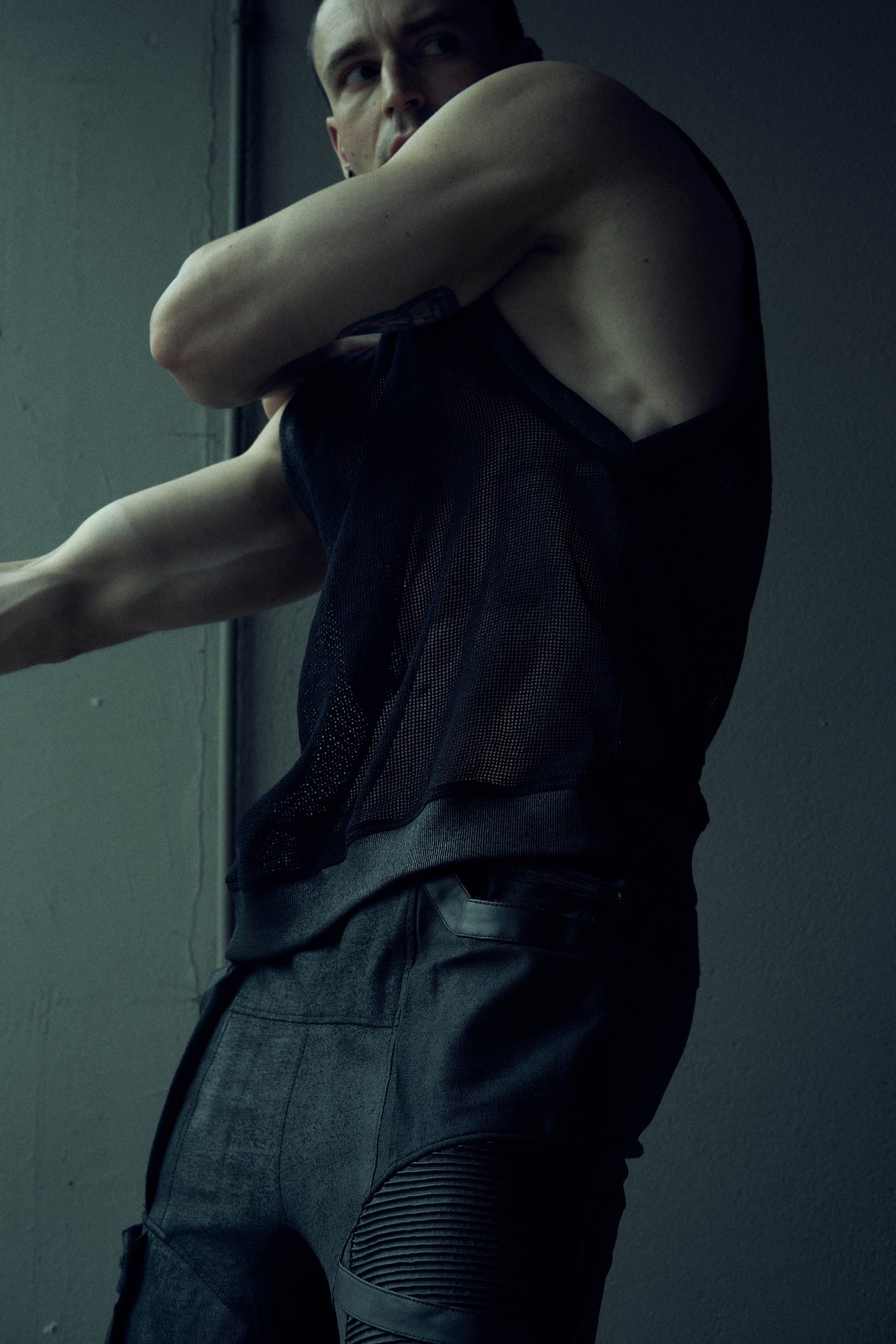 Black SYZMIC EIDOS-214 mesh tank top, side view showing the deep armhole.
