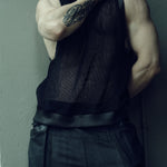 Black SYZMIC EIDOS-214 tank top, front view with the model’s hand at the neck.