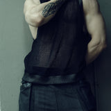 Black SYZMIC EIDOS-214 tank top, front view with the model’s hand at the neck.