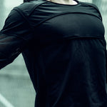 Black SYZMIC EIDOS-215 long-sleeve top showing the round neck and chest construction.