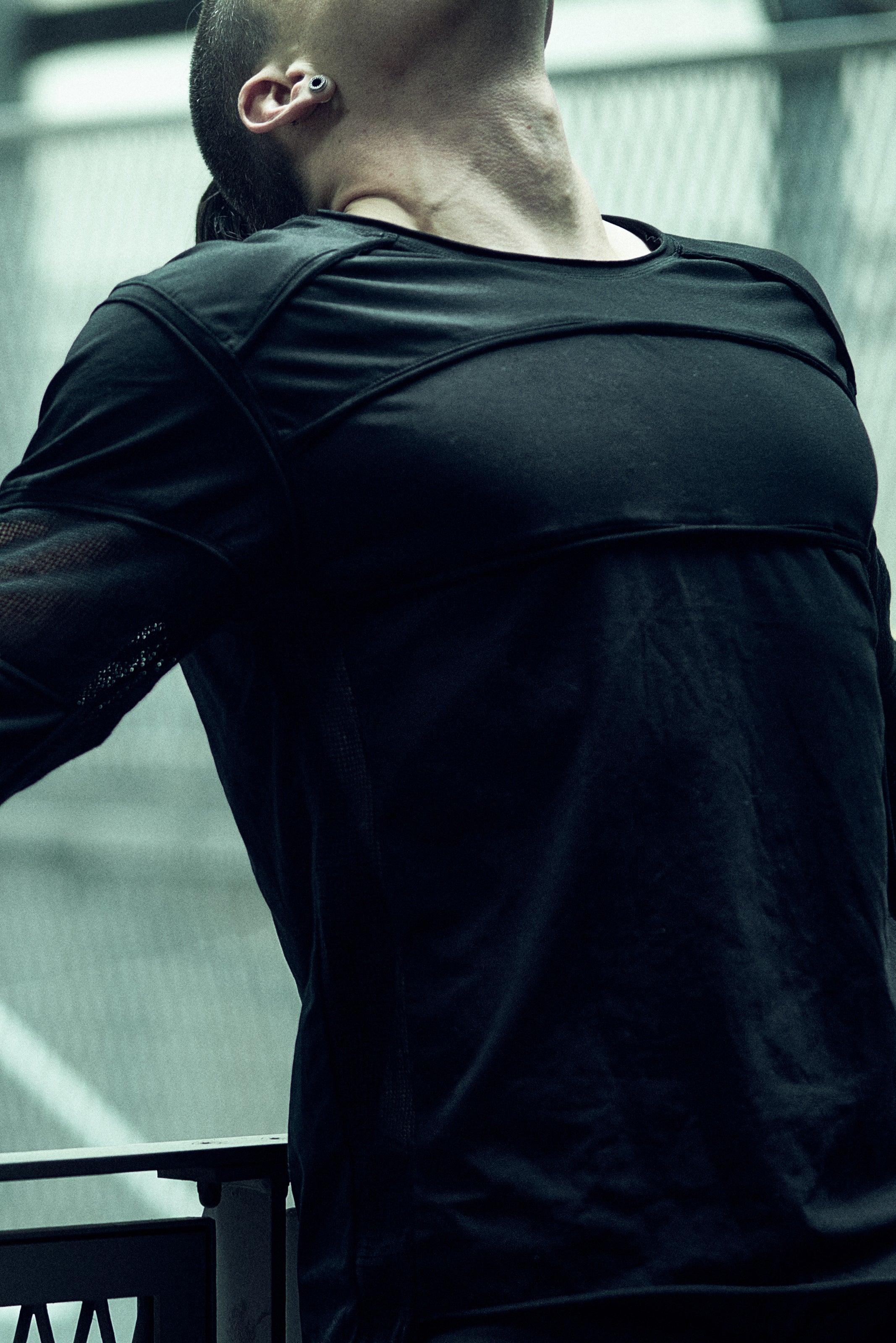 Black SYZMIC EIDOS-215 long-sleeve top showing the round neck and chest construction.
