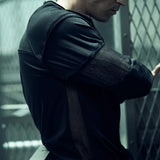 Side view of the black SYZMIC EIDOS-215 long-sleeve top and textured sleeve panels.