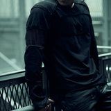 Front view of the black SYZMIC EIDOS-215 long-sleeve top, worn with black trousers.