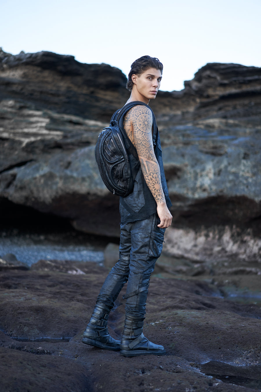 Men's alternative apparel in post-apocalyptic fashion with leather alien backpack