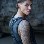 Dark post-apocalyptic harness bag on a men's waxed sleeveless shirt
