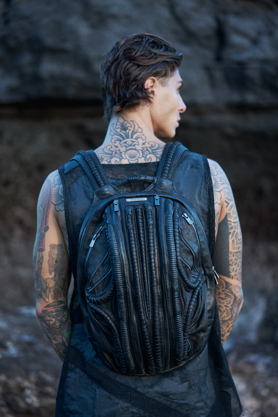 Unisex leather accessories in post-apocalyptic cyberpunk style with men's futuristic textured mesh tank top