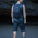 Men's post-apocalyptic apparel with biomorphic backpack, post-apocalyptic grunge top and cargo shorts