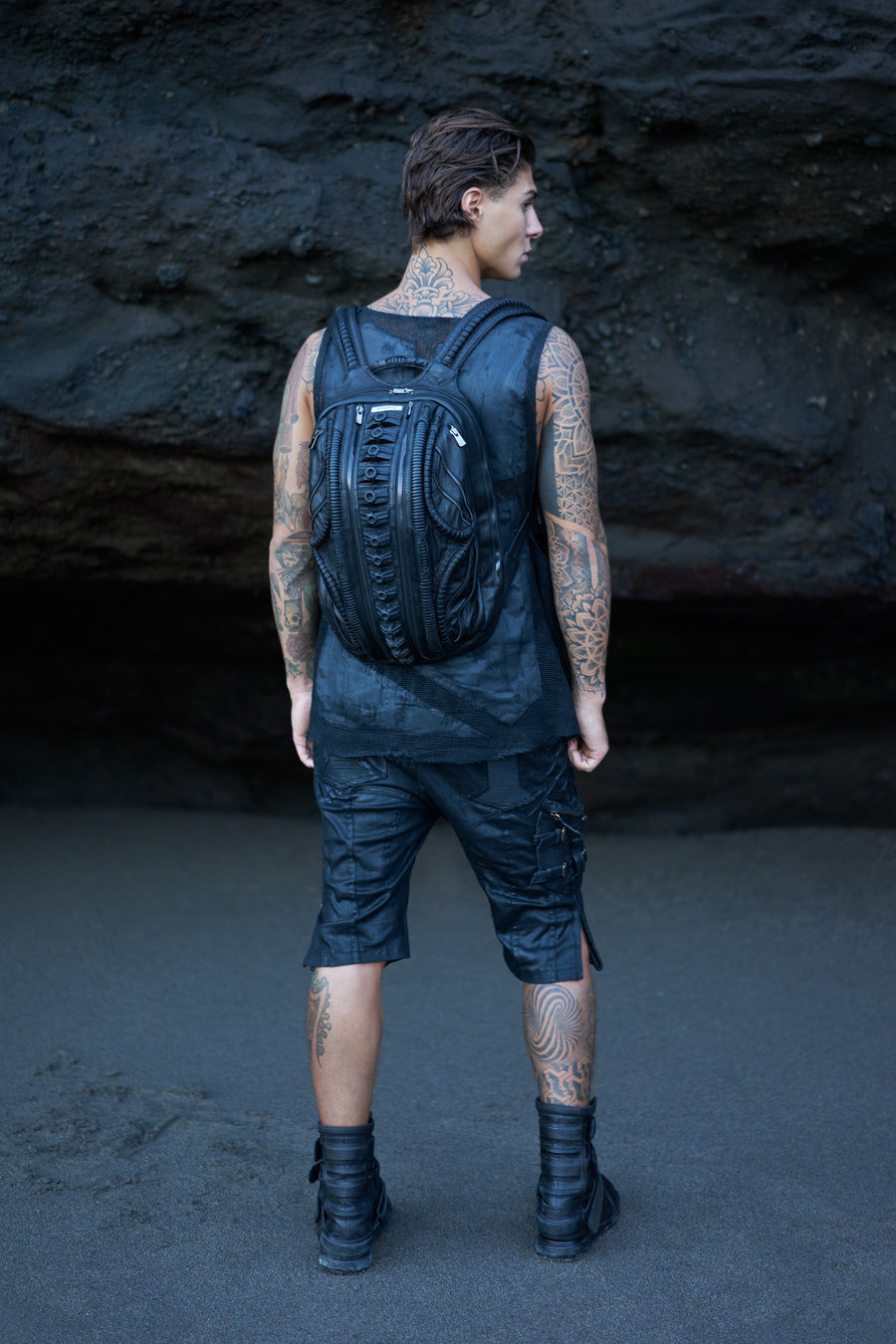 Men's post-apocalyptic apparel with biomorphic backpack, post-apocalyptic grunge top and cargo shorts