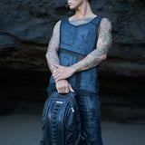 Men's avant-garde streetwear with dark post-apocalyptic clothing and leather backpack, alternative tank top and utility cargo shorts