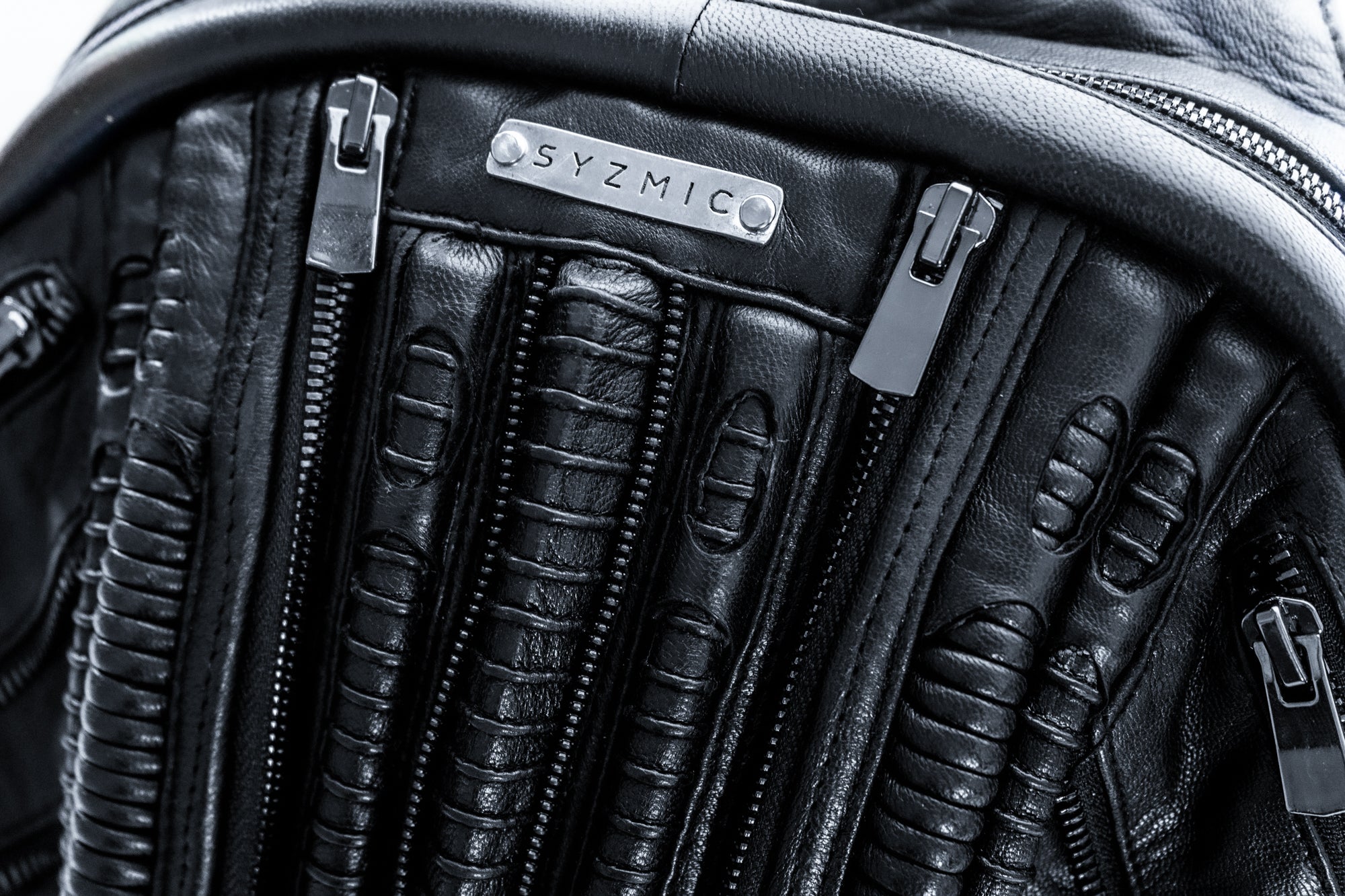 Handcrafted leather bags with biomorphic alien design aesthetic