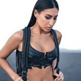 Women's avant-garde streetwear with dark post-apocalyptic bustier top, booty shorts and alien xenomorph leather backpack