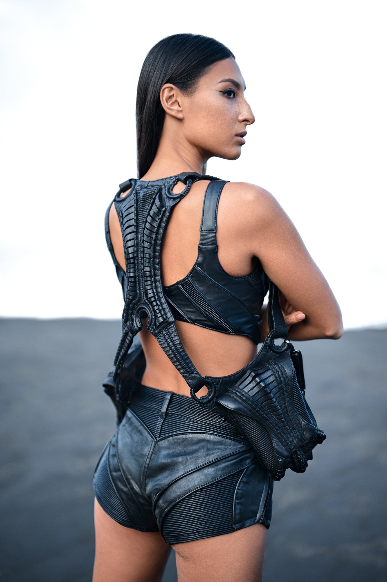 Alien xenomorph inspired back panel with biomorphic exoskeleton construction on leather harness bag & hot pants